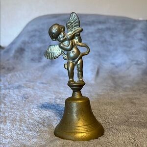 vintage solid brass bell with an angel cherub playing a flute as the handle